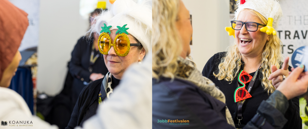 Attendees laughing together at a Sprintcrowd stand at an event, wearing novelty sunglasses